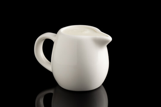 milk jug isolated on black background