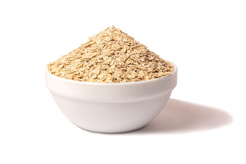 A bowl of dry oatmeal. Healthy, simple breakfast food.
