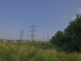 electric power lines over green landscape and road