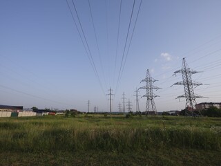 electric power lines over green landscape and road