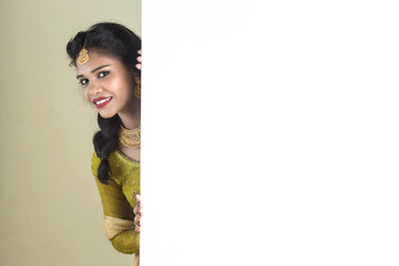 Traditional Girl holding and showing blank white sign board