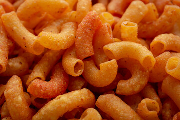 Close up of a pile of macaroni. Background of Pile of pasta
