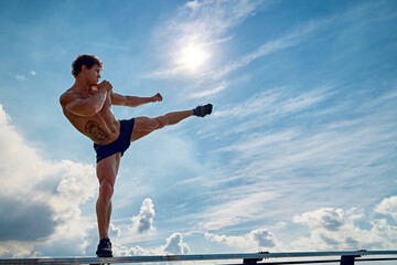 A muay thai or kickboxer training with shadow boxing outdoor