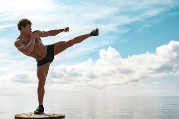 A muay thai or kickboxer training with shadow boxing outdoor