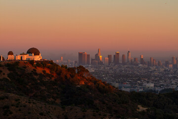 Griffith Observatory with LA skyline in the background at sunset