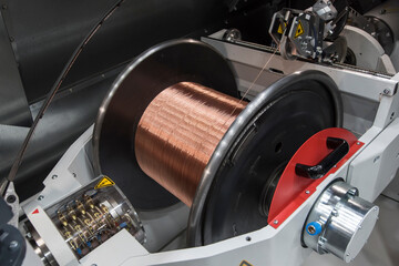 Large industrial copper wire coil. Wire winding machine.