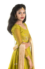 Portrait of beautiful traditional Indian girl posing on white background.