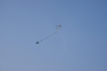 Asian Pakistan hand made kite  in sky blue color clean weather
