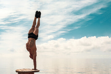 Young man is doing street workout. Handstand exercise, bodyweight
