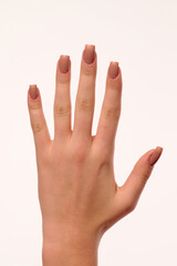 hand with nude manicure on white background