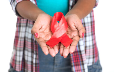 Young woman showing red ribbon HIV, AIDS awareness ribbon, healthcare and medicine concept