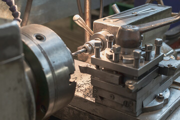 metal processing process, drilling on an old machine in a metalworking workshop