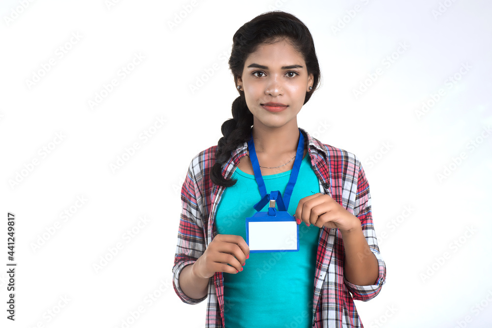 Poster Young woman holding Identification white blank plastic id card.