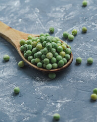 Top view of a wooden spoon on a gray rustic background