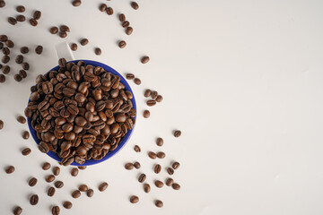 coffee beans in a white glass on a white background, Top view