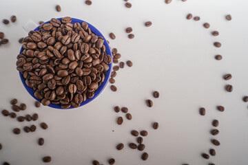 coffee beans in a white glass on a white background, Top view