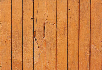 old painted wall made of wooden vertical slats, orange color