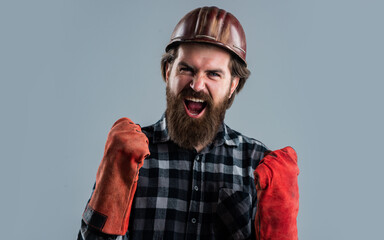 builder guy with working tool. brutal mature hipster wear checkered shirt and hard hat