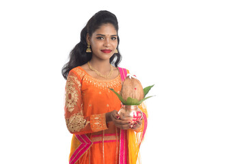 Indian Woman holding a traditional copper kalash, Indian Festival, copper kalash with coconut and...