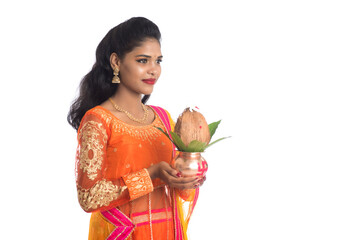 Indian Woman holding a traditional copper kalash, Indian Festival, copper kalash with coconut and...