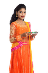 Portrait of a Indian Traditional Girl holding Diya, Girl Celebrating Diwali or Deepavali with...