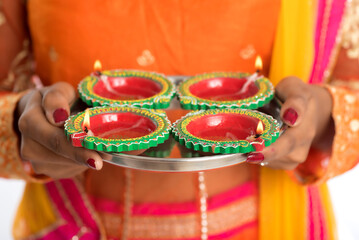 Portrait of a Indian Traditional Girl holding Diya, Girl Celebrating Diwali or Deepavali with...