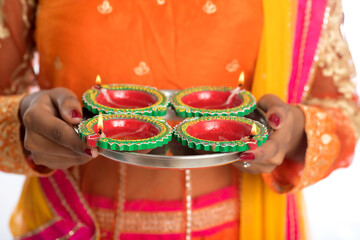 Portrait of a Indian Traditional Girl holding Diya, Girl Celebrating Diwali or Deepavali with...
