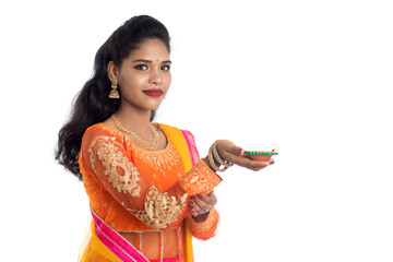 Portrait of a Indian Traditional Girl holding Diya, Girl Celebrating Diwali or Deepavali with...