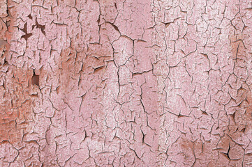 Pink Old flaky paint on a metal surface. Red grunge texture