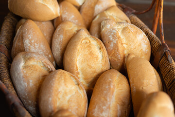 bread in mexican bakery, mexican food, fresh bread, bakery rack with loaves, day, no people, waxed paper, bolillo, french bread
