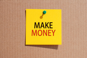 words make money written on yellow square paper and pinned on craft paperboard