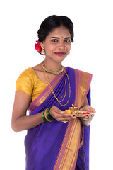Indian woman performing worship, portrait of a beautiful young lady with pooja thali isolated on...