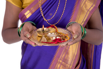 Indian woman performing worship, portrait of a beautiful young lady with pooja thali isolated on...