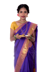 Indian woman performing worship, portrait of a beautiful young lady with pooja thali isolated on...