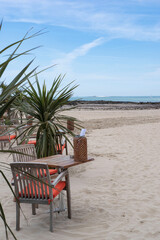 Restaurant table and chair on a beach by the sea