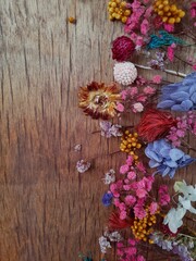 Dried flowers on rustic wooden planks background mobile photo