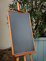 Empty sandwich chalkboard stand in restaurant interior ready to be filled