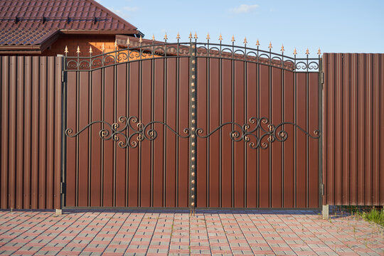 Simple forged gates with metal profile sheet