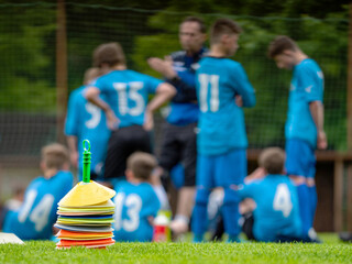 Football players have meeting with coach within football match