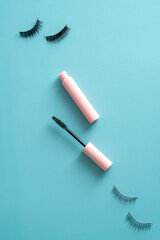 Mascara with false eyelashes on color background. Flat lay, top view.