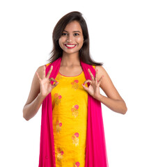 Smiling cheerful girl showing sign isolated on white background