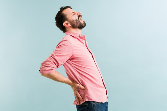 Attractive man having a lot of back pain