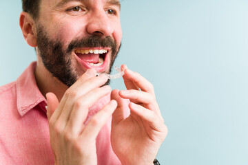 Adult man using transparent braces or retainer