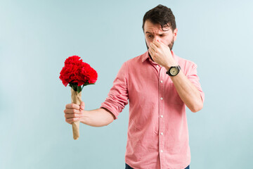 Adult man with an itchy nose and sneezing