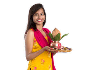 Indian girl holding a traditional copper Kalash with Pooja Thali, Indian Festival, copper Kalash...