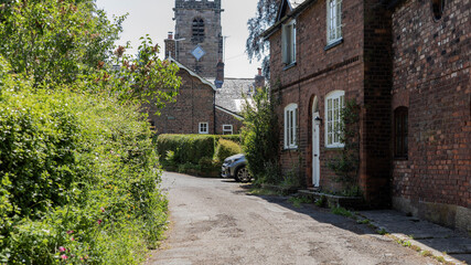 Fototapeta premium Looking down a village street at a church