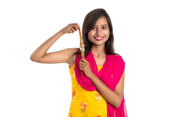 Beautiful Indian girl showing Rakhis on occasion of Raksha bandhan. Sister tie Rakhi as symbol of intense love for her brother.