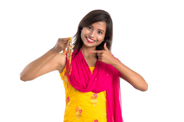 Beautiful Indian girl showing Rakhis on occasion of Raksha bandhan. Sister tie Rakhi as symbol of intense love for her brother.