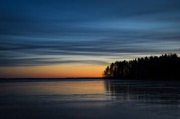 Fototapeta na wymiar First ice on lake Pyhäselkä Sunset Island Finland