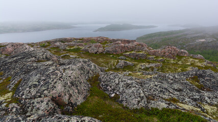 Fototapeta na wymiar Granite hills, lake, and fog.
